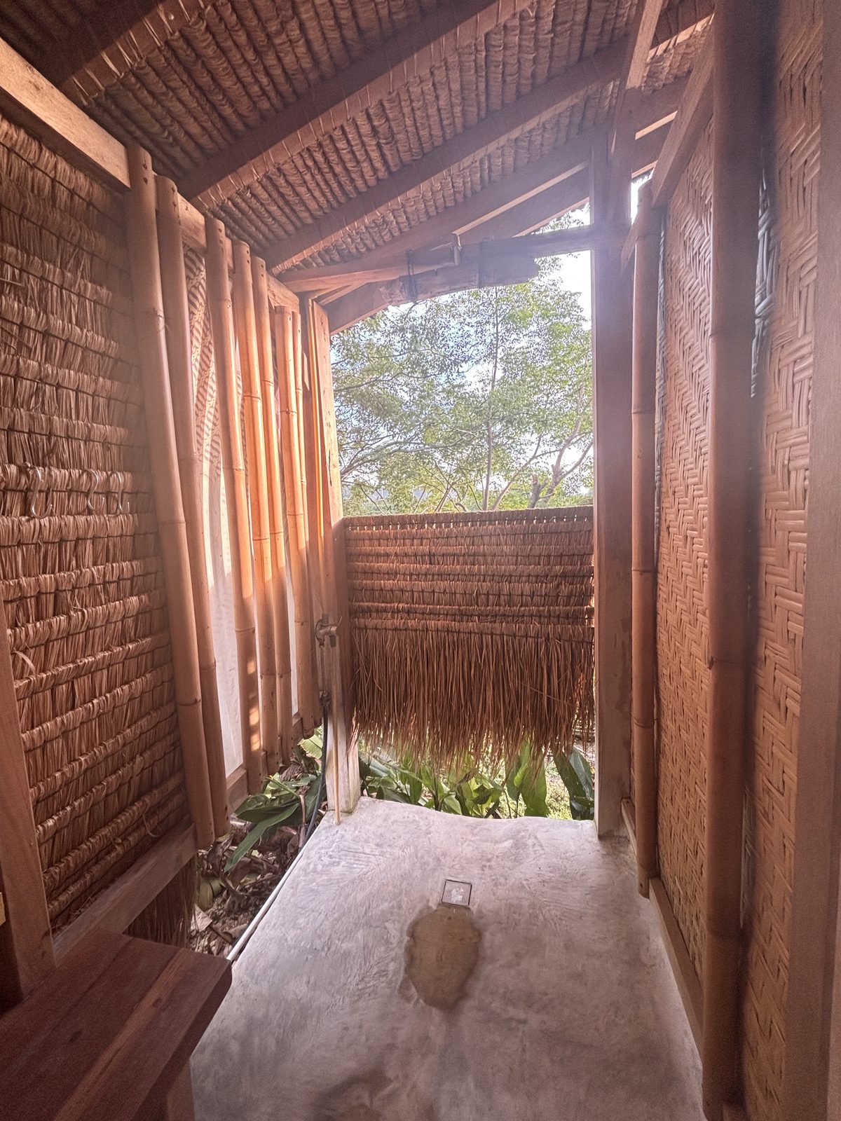 Semi-open outdoor shower area surrounded by bamboo at the Big Bungalow