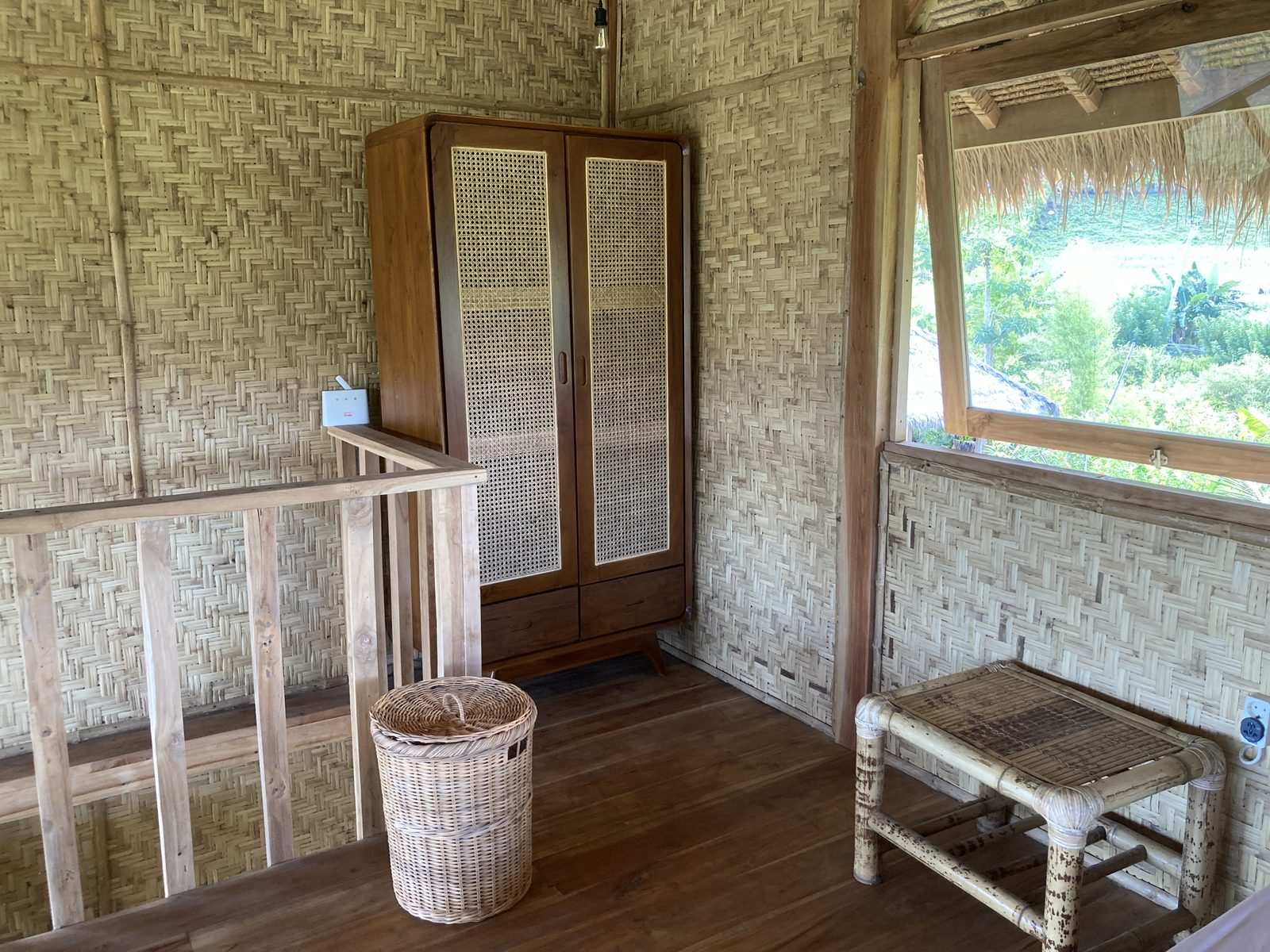 Upper floor wardrobe area at Big Bungalow with bamboo wall and rattan stool