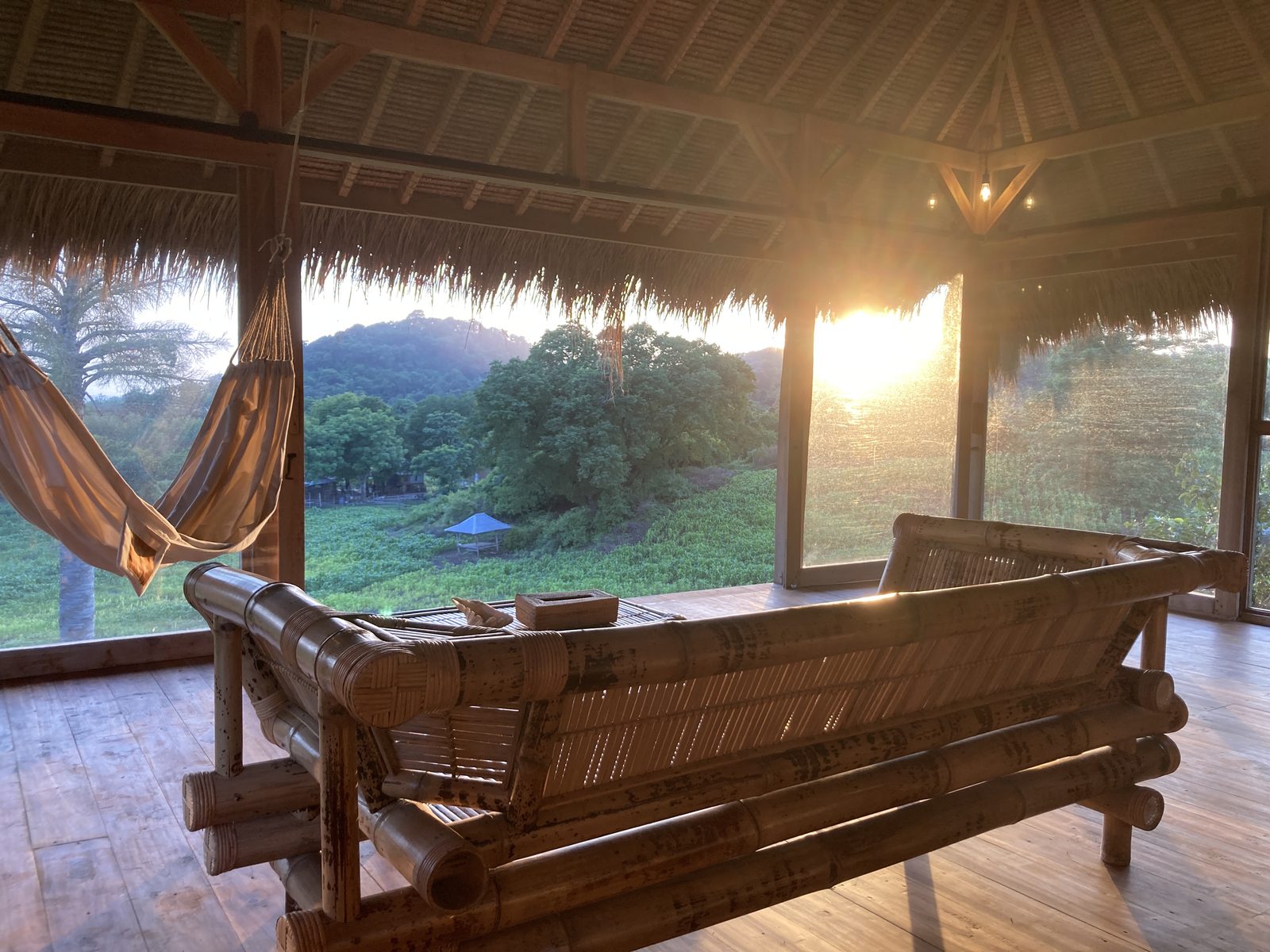 Sunset view from Big Bungalow with hammock and bamboo sofa