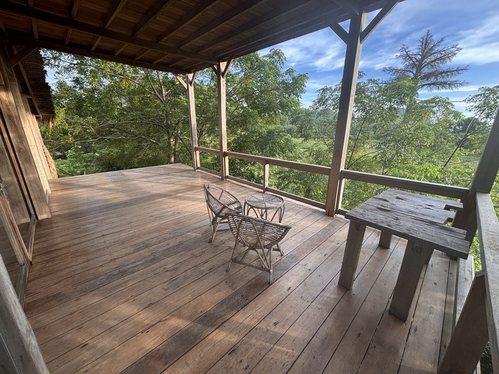Wooden deck terrace of the Big Bungalow under blue sky